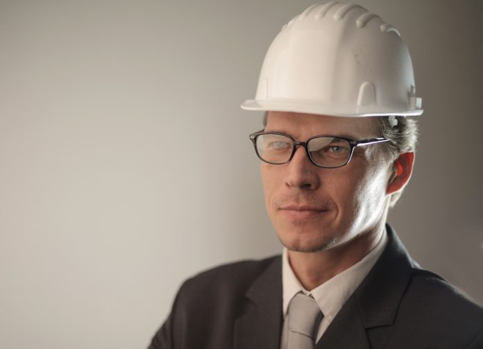 man-in-black-suit-jacket-wearing-hard-hat-3776969