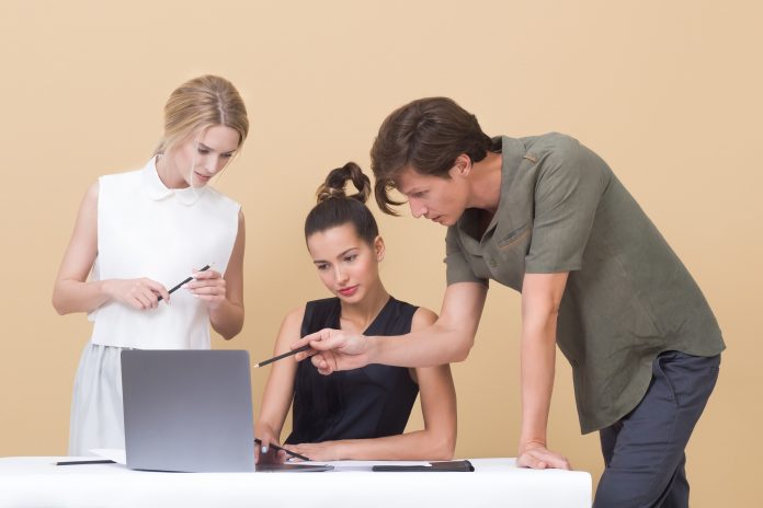 two-woman-and-one-man-looking-at-the-laptop-1036641